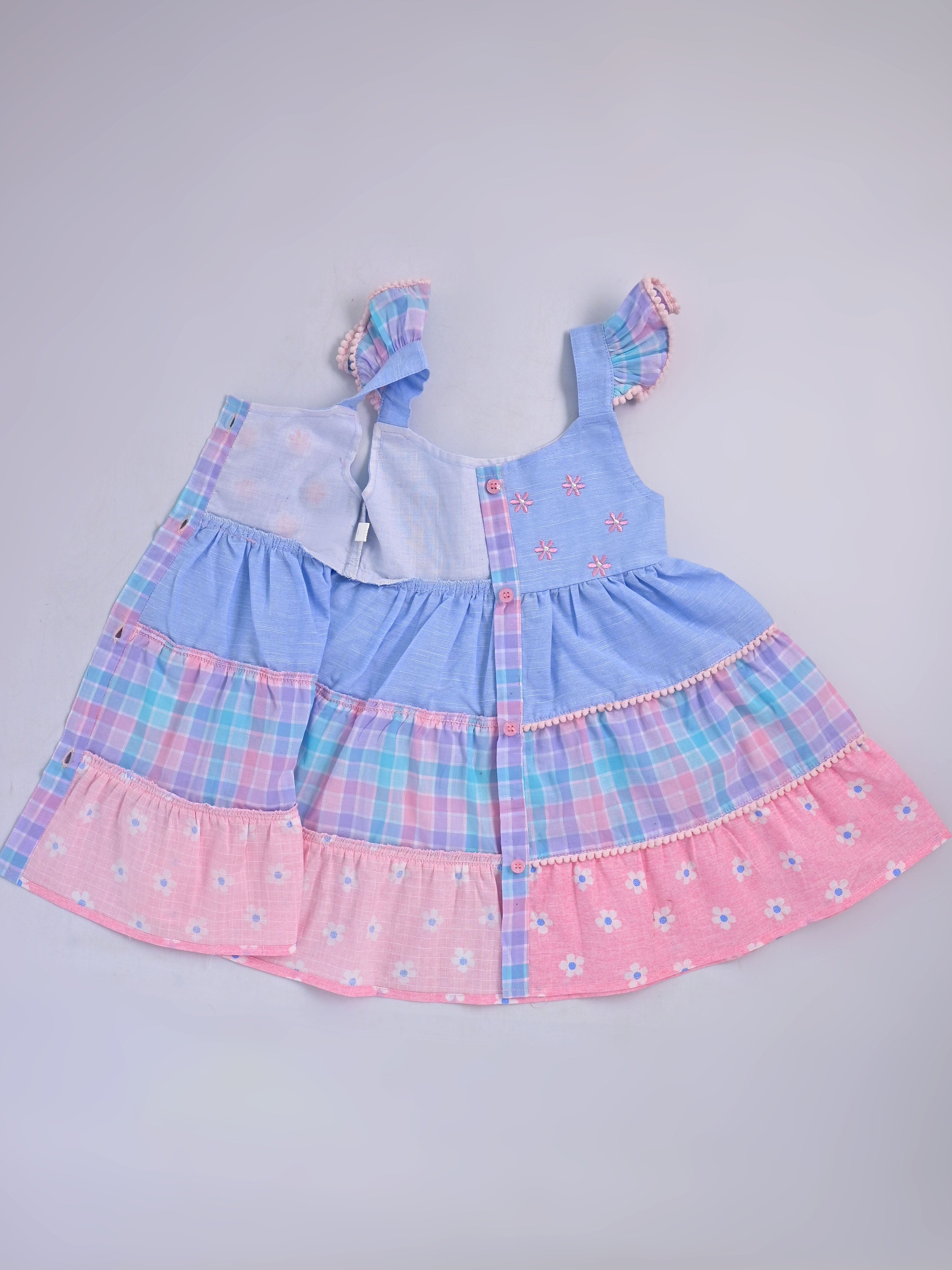 Hopebow Pastel Bloom tiered cotton baby girl frock with coordinating bucket hat, styled flat lay