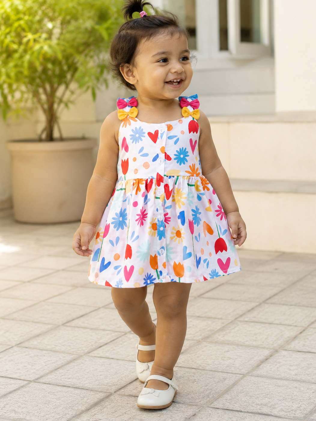 Baby girl wearing Hopebow heart and bloom print frock
