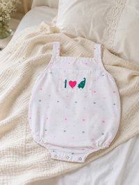 Baby wearing Hopebow pastel dot ivory romper