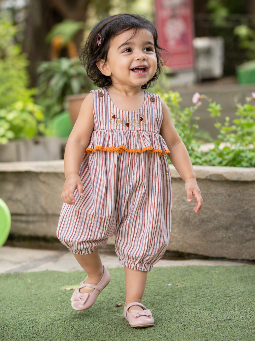 Baby girl wearing Hopebow warm-stripe cotton romper