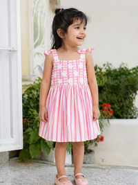 Girl wearing Hopebow pink striped summer frock with shoulder ties
