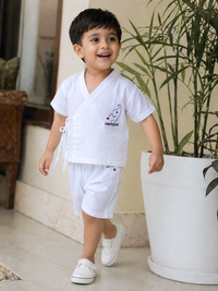Boy wearing Hopebow heritage white shirt and shorts