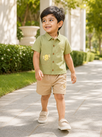 Boy wearing Hopebow sage shirt with embroidered elephant motif