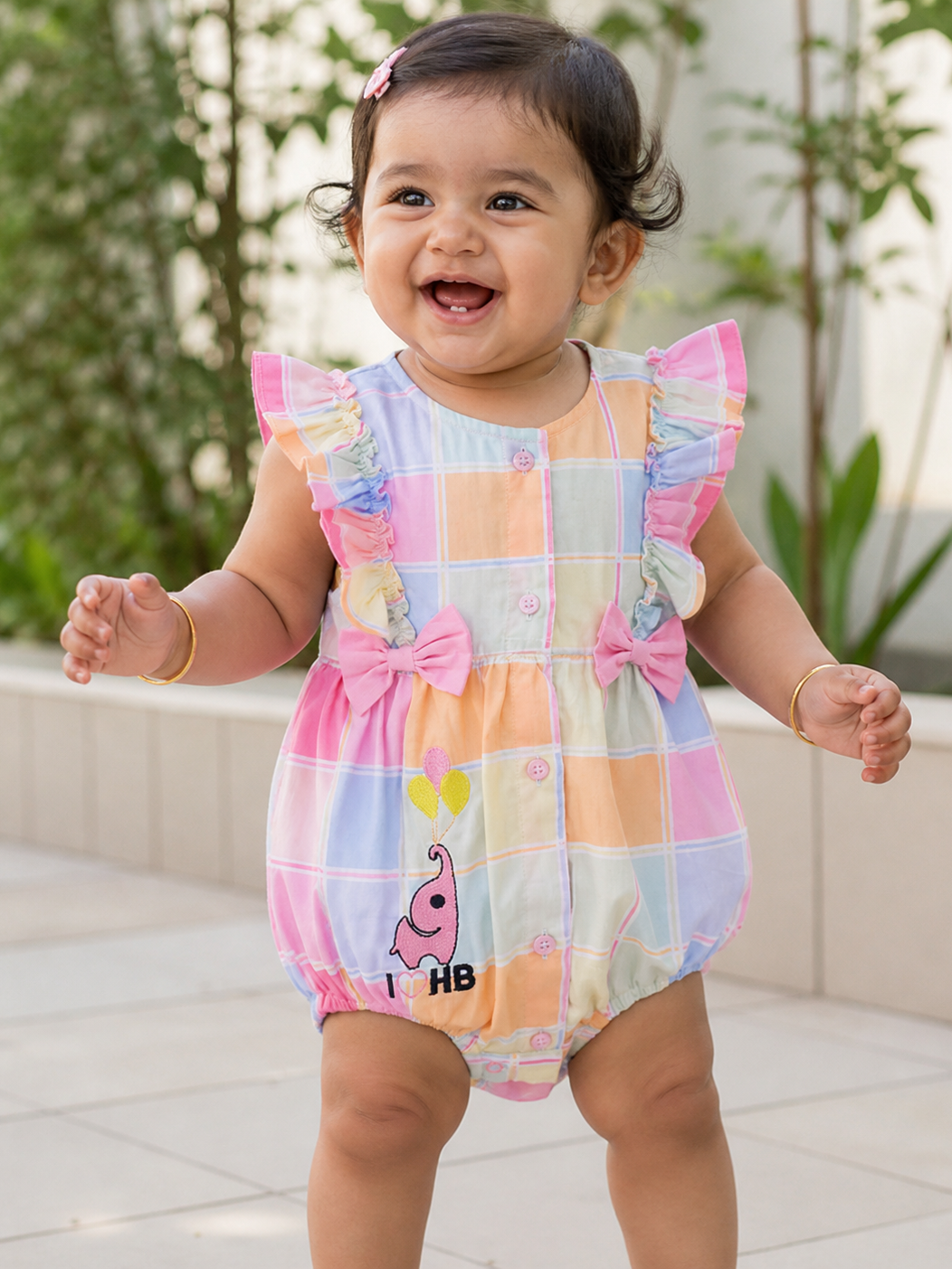 Baby girl wearing Hopebow patchwork pastel check romper
