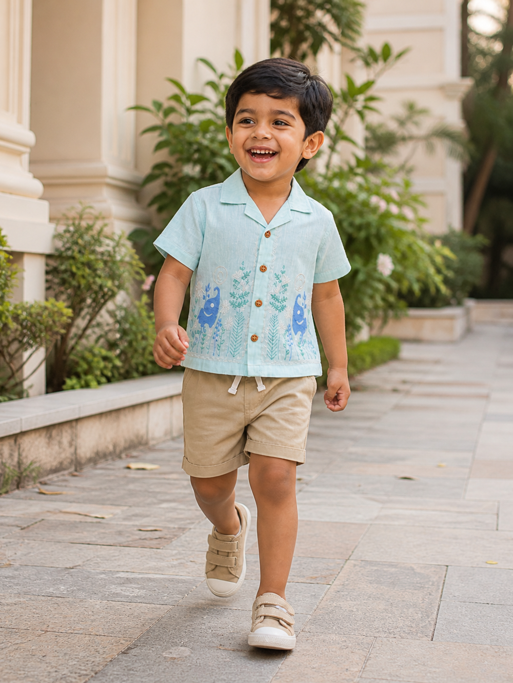 Boy wearing Hopebow aqua sea-life print shirt with beige shorts