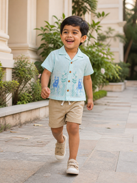 Boy wearing Hopebow aqua sea-life print shirt with beige shorts