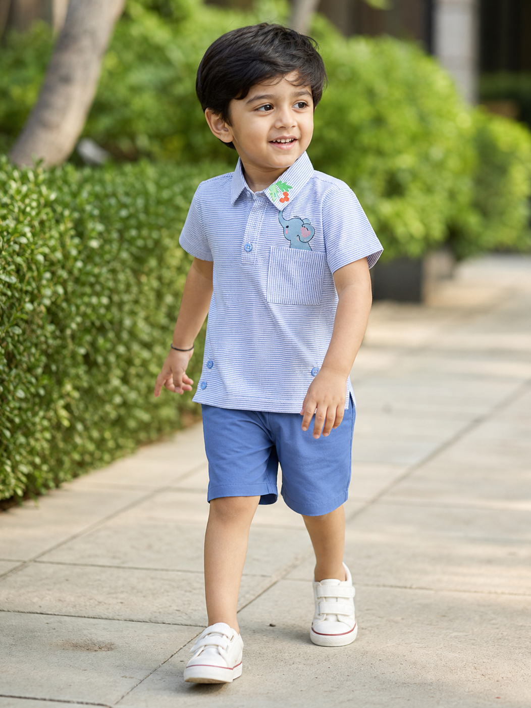 Boy wearing Hopebow blue striped shirt with deeper blue shorts