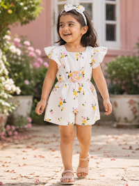 Girl wearing Hopebow ivory floral romper with ruffle straps