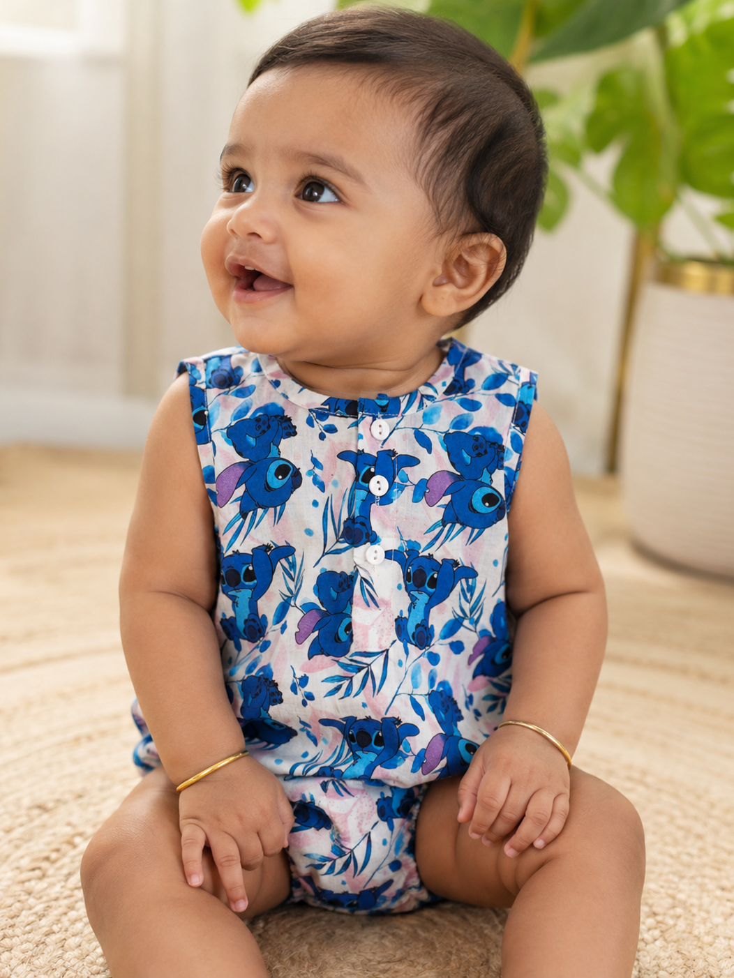 Baby wearing Hopebow tropical print blue romper