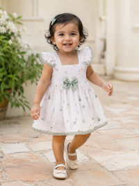 Baby girl wearing Hopebow sage bow cotton frock