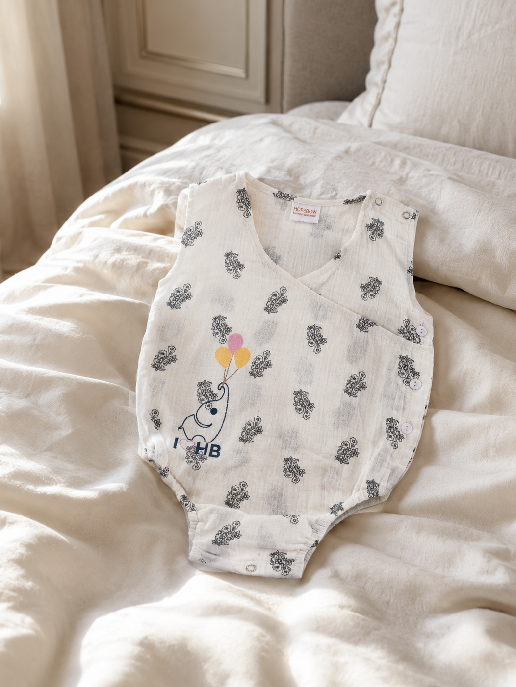 Baby wearing Hopebow ivory bloom floral romper