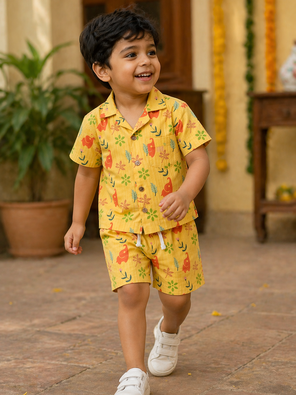 Boy wearing Hopebow yellow safari print shirt and shorts
